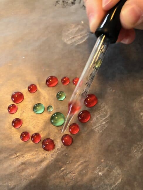 using an eye dropper (great fine motor practice!) to paint with colored water on wax paper