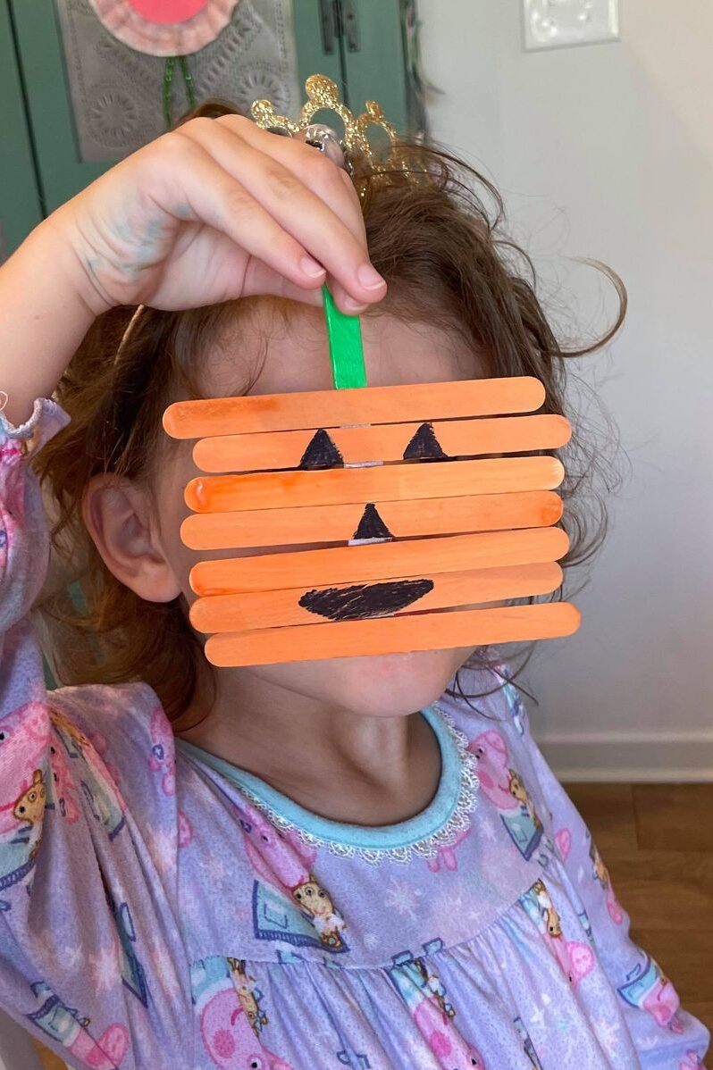 Popsicle stick pumpkin craft and fine motor activity for kids to make and play with - more than just a craft.