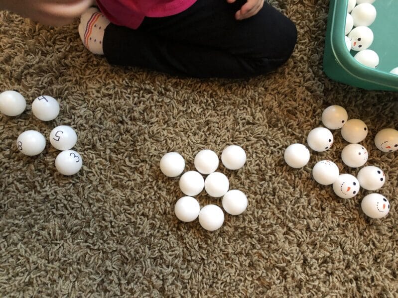 sorting snowman ping pong balls by numbers, plain and of course, snowman faces