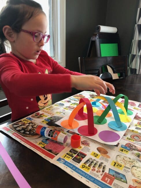 Matching colors, fine motor practice, and creating a simple craft all in one simple kids activity that just needs paper, scissors and glue!