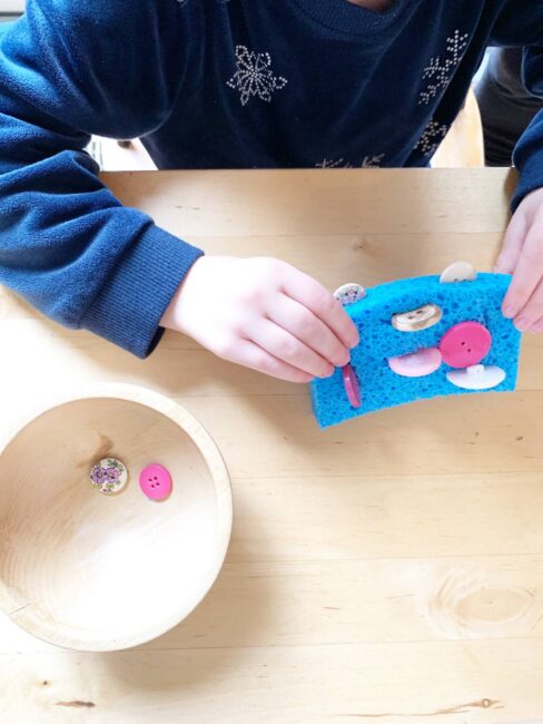 Turn a classic household sponge into a super fun and simple button busy bag with this quick and simple idea. Perfect challenge for toddlers!