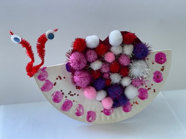 Spread love this spring with an winsome and super simple pom pom and paper plate heart snail craft for toddlers and preschoolers to make.