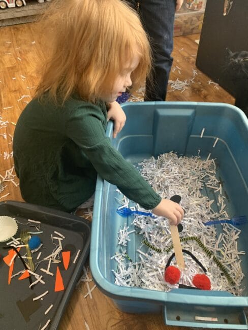 Toddlers and preschoolers will love the sensory experience of playing with shredded paper and building a snowman in the bin or on the floor!