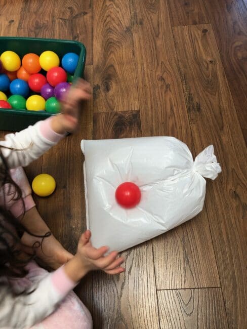 Name the colors, count the balls, or just have silly popping fun with this quick prep game that is sure to get laughs and wear the kids out.