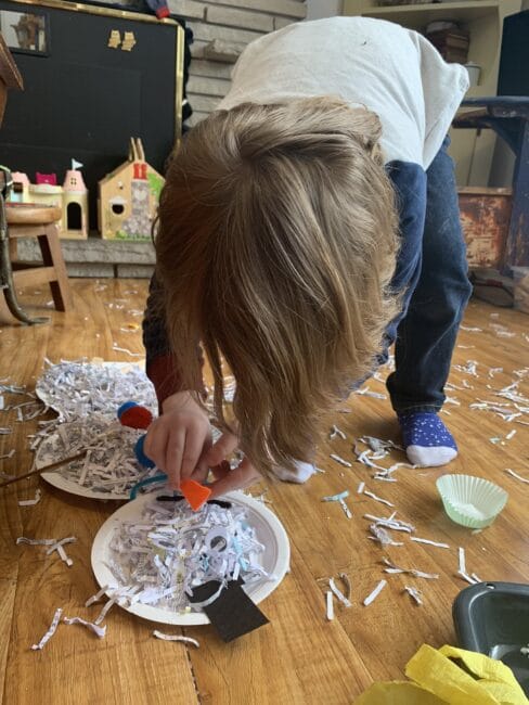 Let it get a little messy! Grab the recyclable shredded paper bin and build some sensory snowmen together!