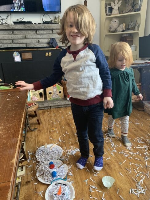 Let it get a little messy! Grab the recyclable shredded paper bin and build some sensory snowmen together!