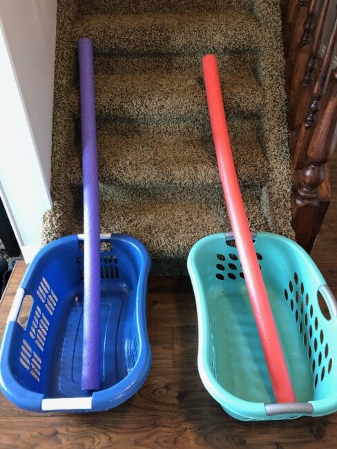 Make a marble race track game with pool noodles and laundry baskets on the stairs! Great for fine motor skills.