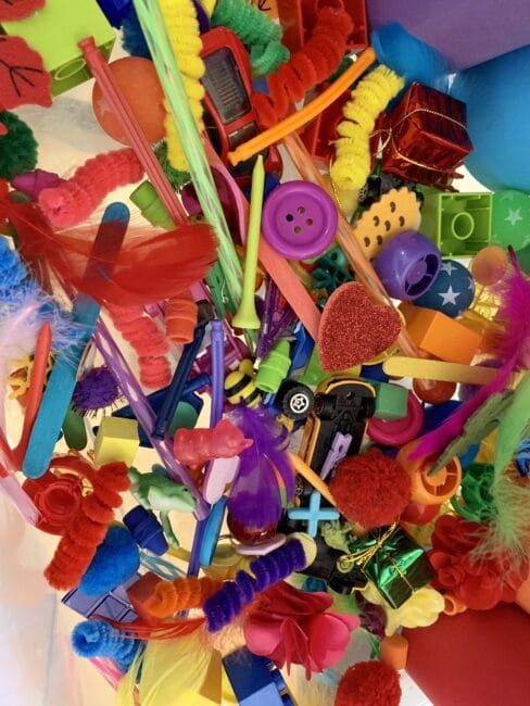 No broom or vacuum needed to clean up after this mess free rainbow sorting sensory bin that gets toddlers to explore textures while learning color recognition!