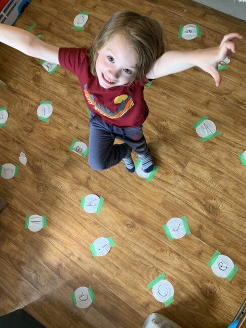 Practice spelling your name by connecting letters in a giant floor game of connect the dots using muffin liners and tape!