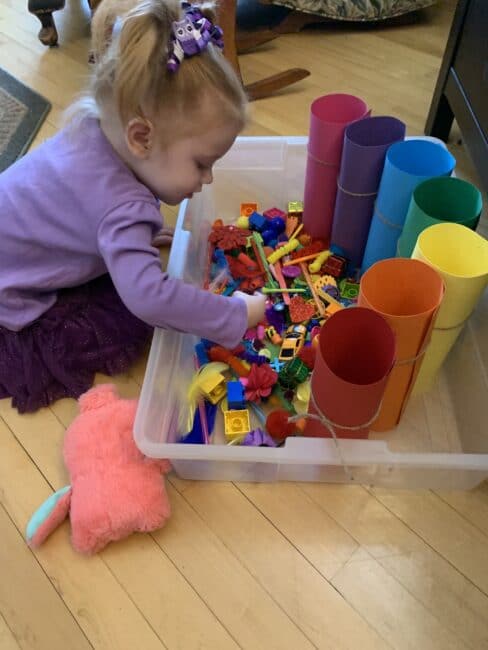 Sort household supplies by the colors of the rainbow in this totally mess free sensory bin idea perfect for toddlers at home.
