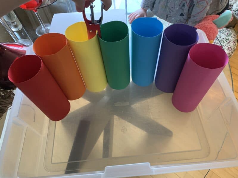 staple colored tubes together in an arch shape that fits inside the bin.