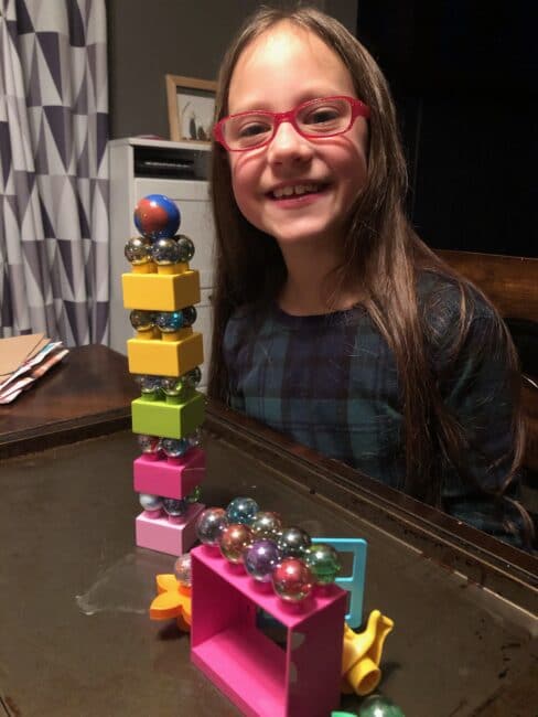Building towers with marbles and balancing duplo LEGO blocks together.