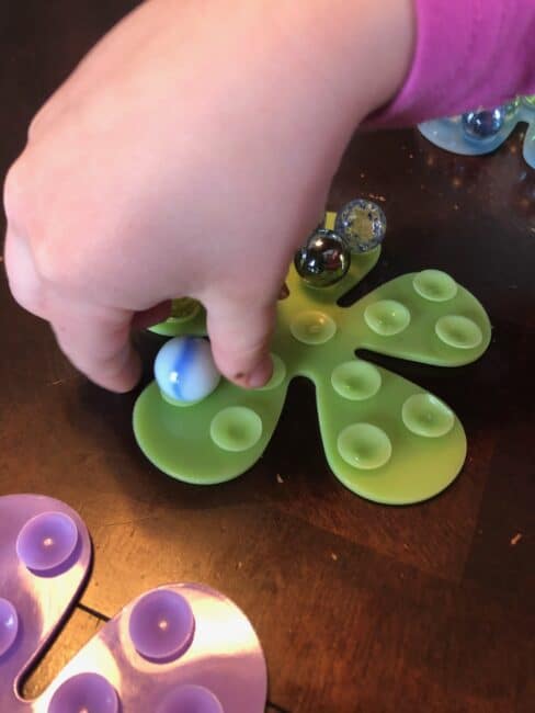 Balancing marbles on suction cups.