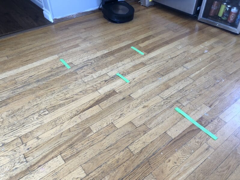 Place painters tape lines in various spots along the floor, sticky side up.