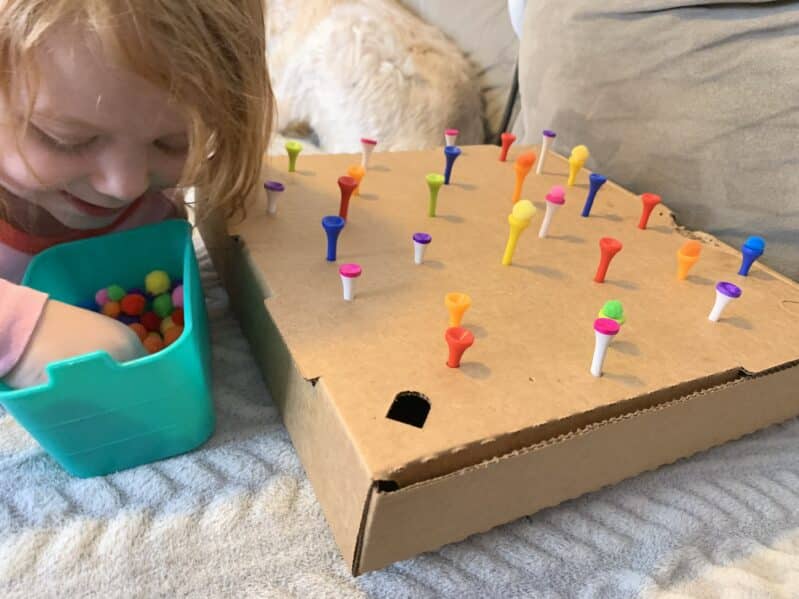 Hammer in the golf tees, and then challenge your kids to balance the pom poms on top! Making rainbows, or just matching colors, either way your little ones will have a blast!