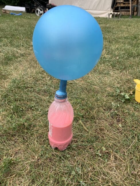 Attach the balloon to the bottle of mixture to fill the stress ball