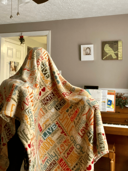 Play ghost chase game or hide-and-seek the ghost game with blankets at home for gross motor kid fun indoors.