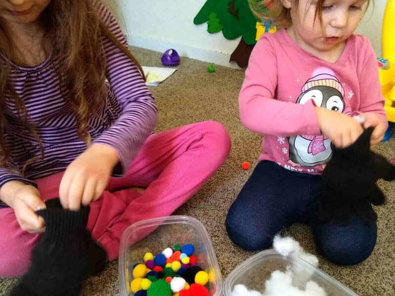 This fine motor activity for toddlers and preschoolers is so simple and requires no real prep. Just grab materials like pom poms, newspaper, or cotton balls and start stuffing gloves.