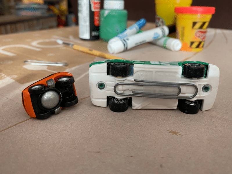 Make magnetic cars by adding on a paper clip with tape