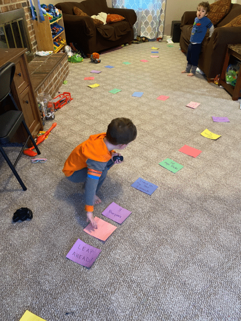 Create a life size board game for the whole family to get the wiggles out and learn about taking turns and counting using simple household supplies. 