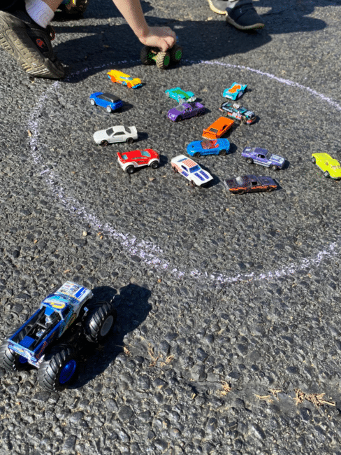 the object of playing Monster Truck Marbles is to knock the toy cars out of the circle and collect them in your own "junk yard"