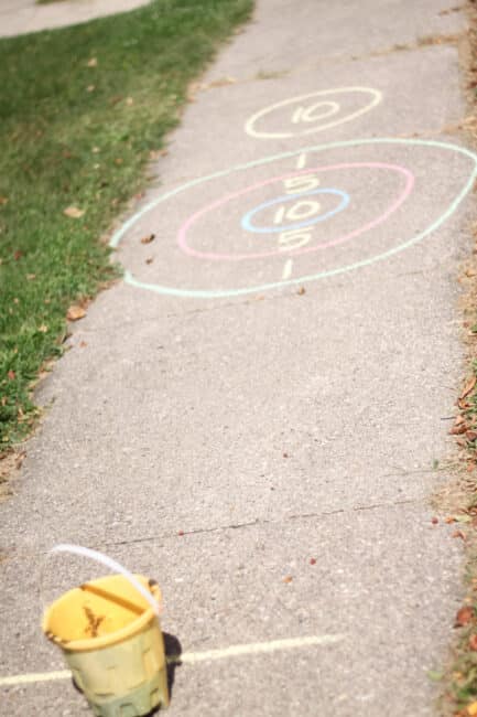 Draw a target on the sidewalk with chalk and mark a starting point for kids to know where to stand.