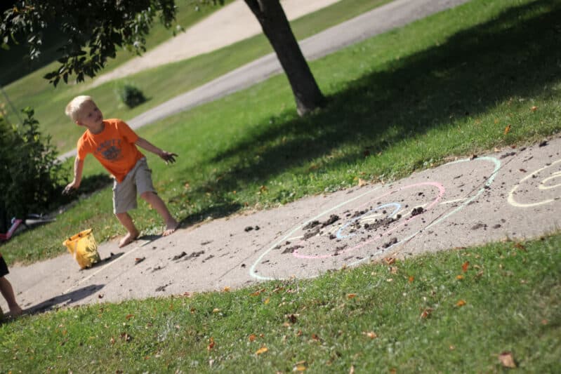 Make a chalk target on the sidewalk and then have a blast throwing mud balls for excellent and hilarious target practice that’s perfect for preschoolers gross motor play outdoors. Plus cleanup is fun with a hose: clean the sidewalk and the kids in one shot!