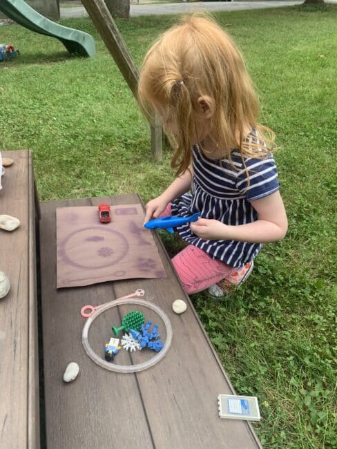 Shadow puzzles with construction paper and loose parts are a great backyard science experiment.
