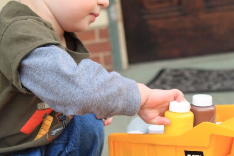 Stacking paints in his dump truck to kick off the painting activity
