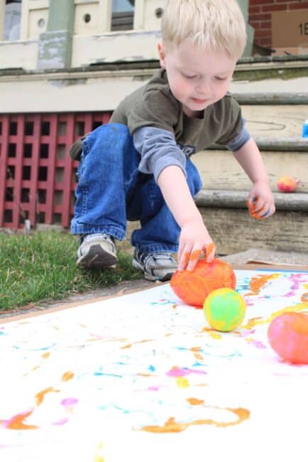 Egg rolling painting using plastic eggs in a big movement way!