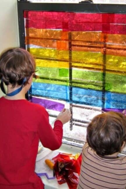 Make a beautiful rainbow on a window! DIY this gorgeous cellophane window art with your kids.