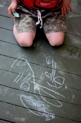 Preschooler Drawing with Sidewalk Chalk