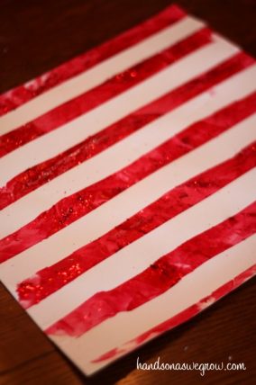 Red and white striped candy cane painting made with tape resist