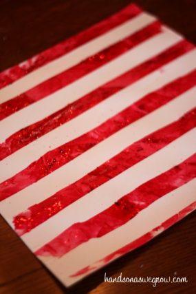 Red and white striped candy cane painting made with tape resist