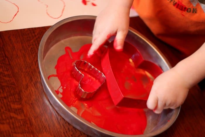 Heart shape cookie cutter make a great painting tool for toddlers and preschoolers to get creative for Valentine’s Day themed art activity at home.