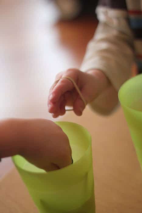 A fine motor activity that focuses on hand strength using rubber bands.