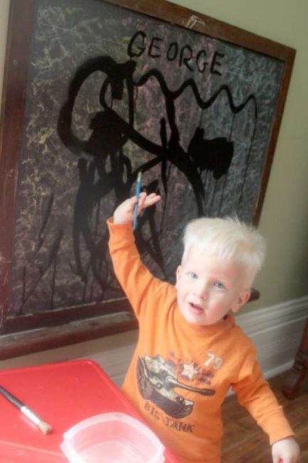 Painting on the chalkboard with water.