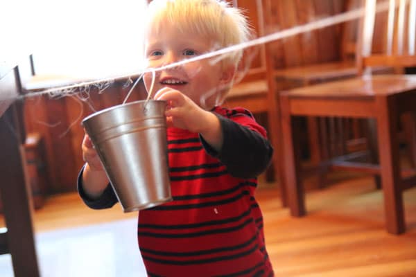 Bucket toddler activity on a clothesline