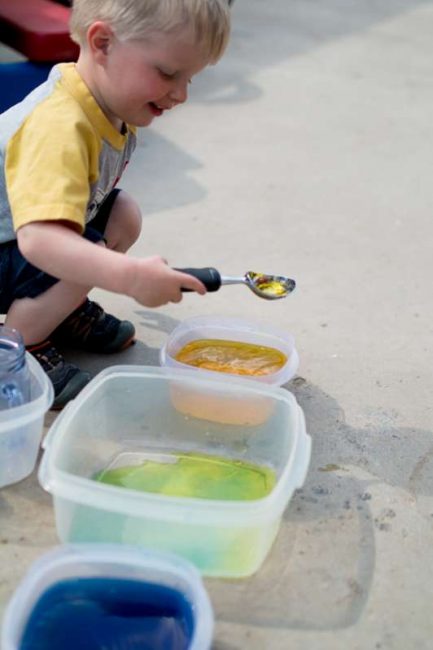 Mixing yellow and blue water together to see what it makes