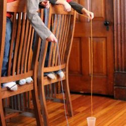 What string do you think will be the easiest to get into the cup? A long one or a shorter one? Amazing coordination activity for kids