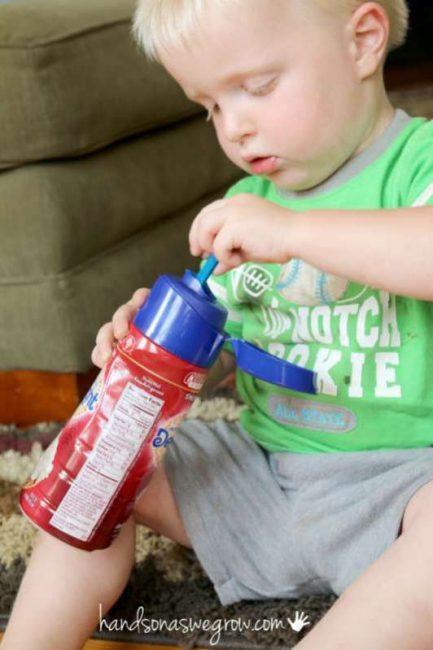 A fine motor activity for toddlers to do with a plastic bottle