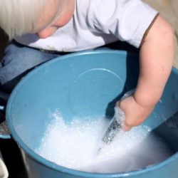 Making bubbles and playing with them - simple toddler sensory activity