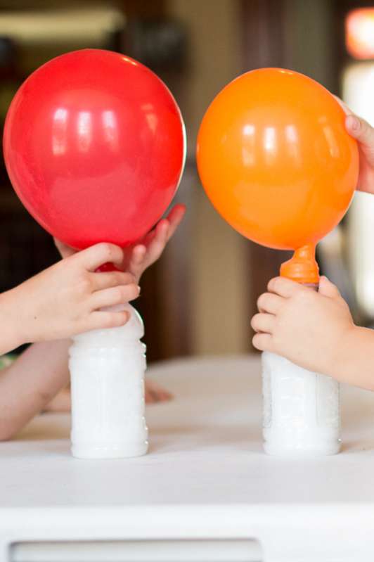 Blowing up balloons with a gas (not helium!) - one of 10 hands-on science & math activities for the kids to LOVE!