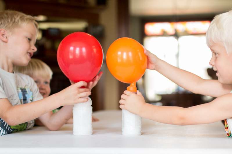 Blowing up balloons with a gas (not helium!) - one of 10 hands-on science & math activities for the kids to LOVE!