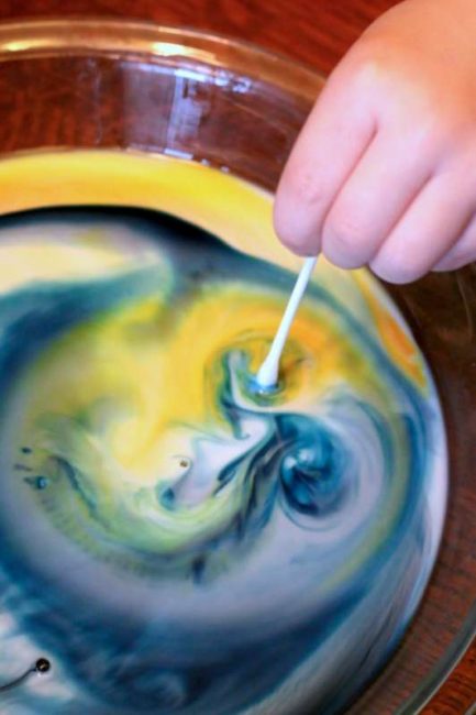 Magically mix primary colors with the color changing milk experiment!