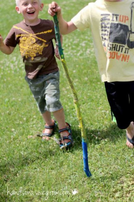 kids using their walking sticks on summer hikes and walks around town