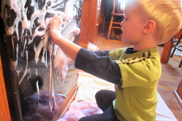 Playing with soapy sensory foam cleans too!