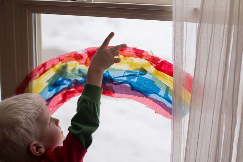 A rainbow suncatcher made with the three primary colors to add a twist of learning about color mixing too!