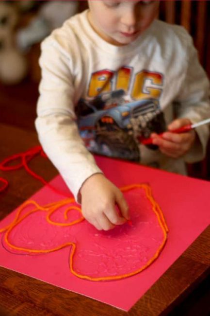 Your toddler will love making loopy piles of yarn for a Valentine's Day heart craft!