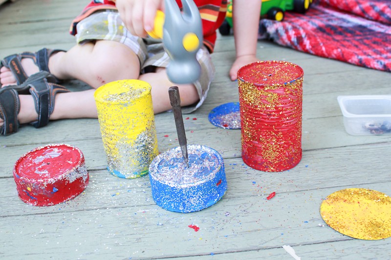 Pounding nails - to make holes in the cans - is great fine motor practice!